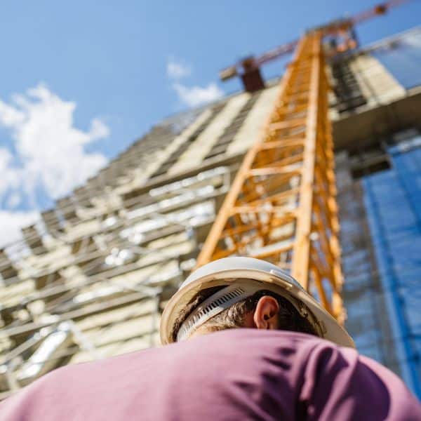 Image of a tall building and construction worker